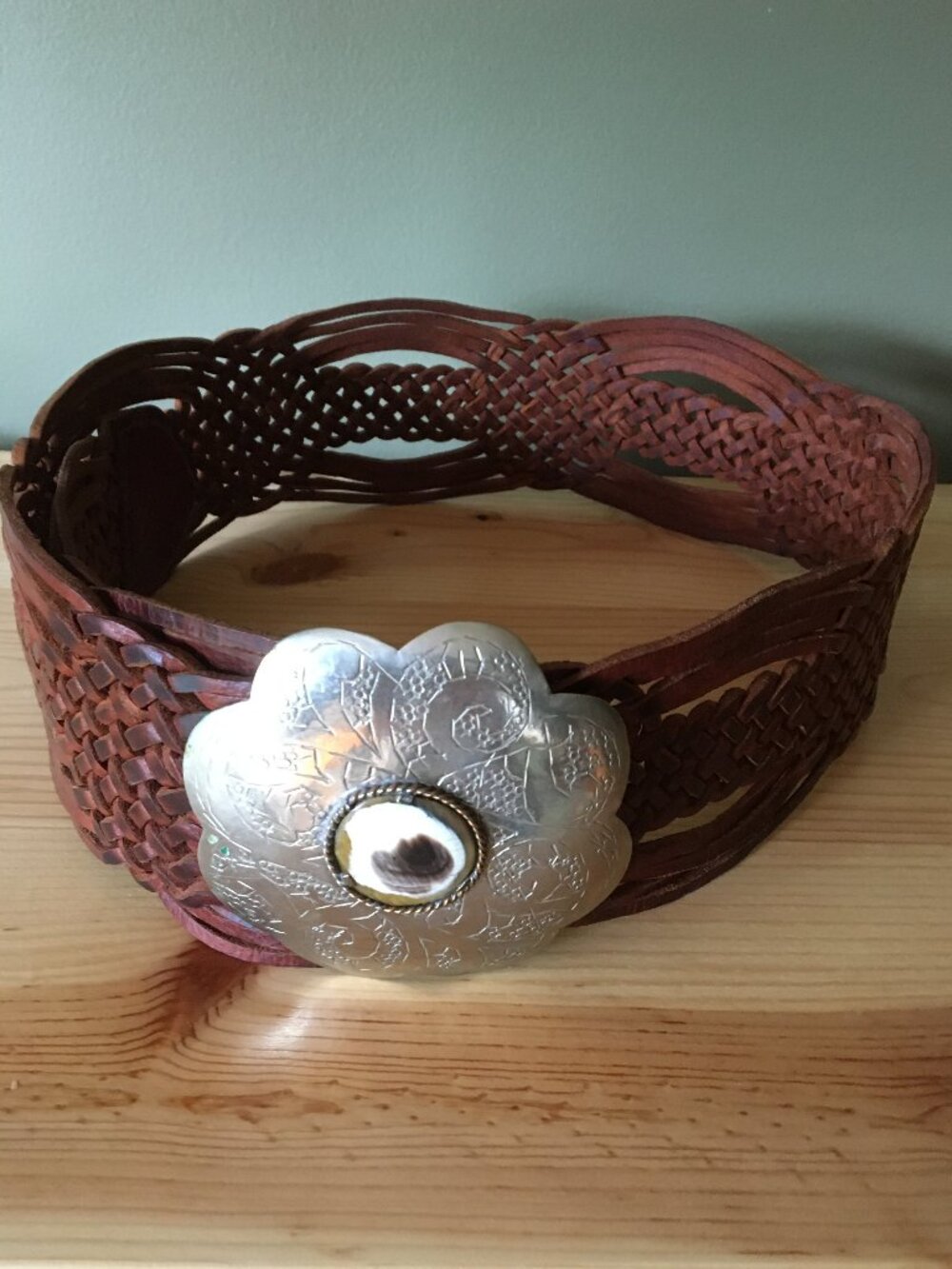 Large leather belt with metallic buckle.